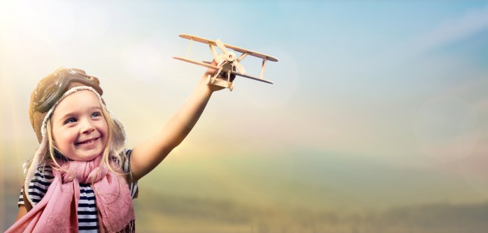 Freedom To Dream - Joyful Child Playing With Airplane Against The Sky