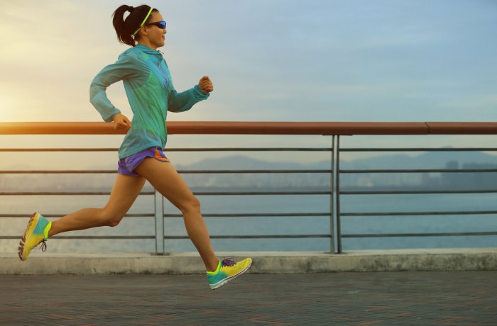 healthy lifestyle young fitness woman running at seaside
